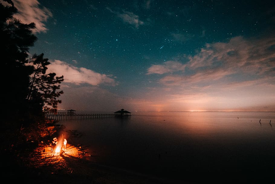 campfire with body of water, bonfire near body of water, ocean