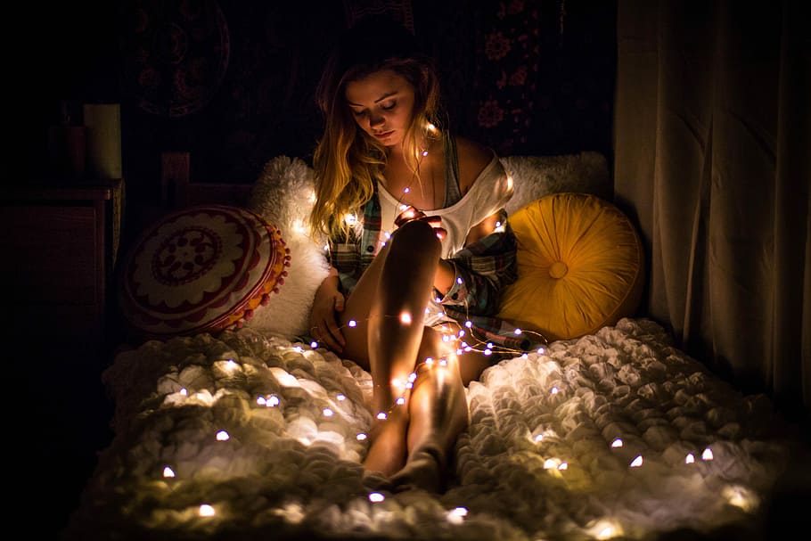 Breathe - Lights, silhouette photography of woman lying on bed with string lights