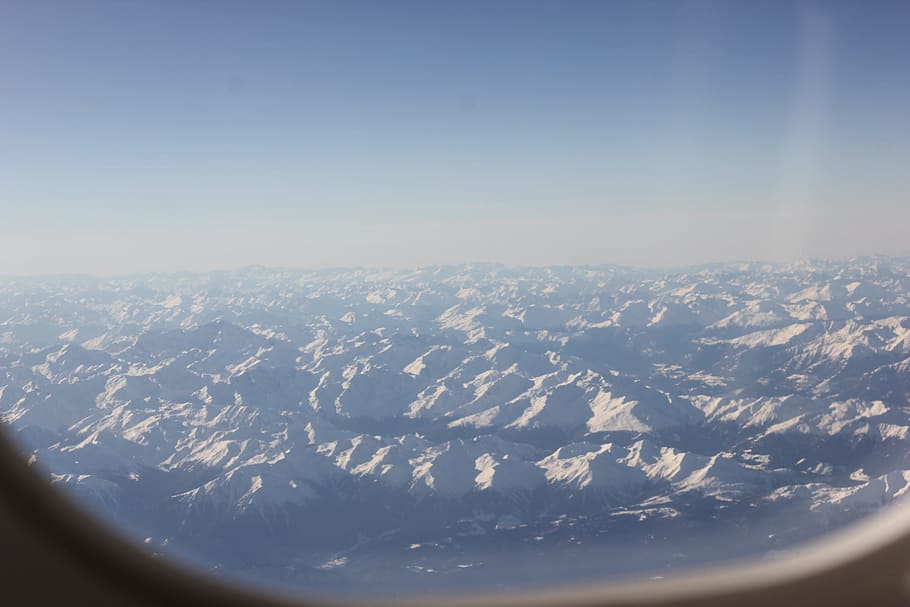 white mountains, airplane window showing mountains, plain, snow HD wallpaper