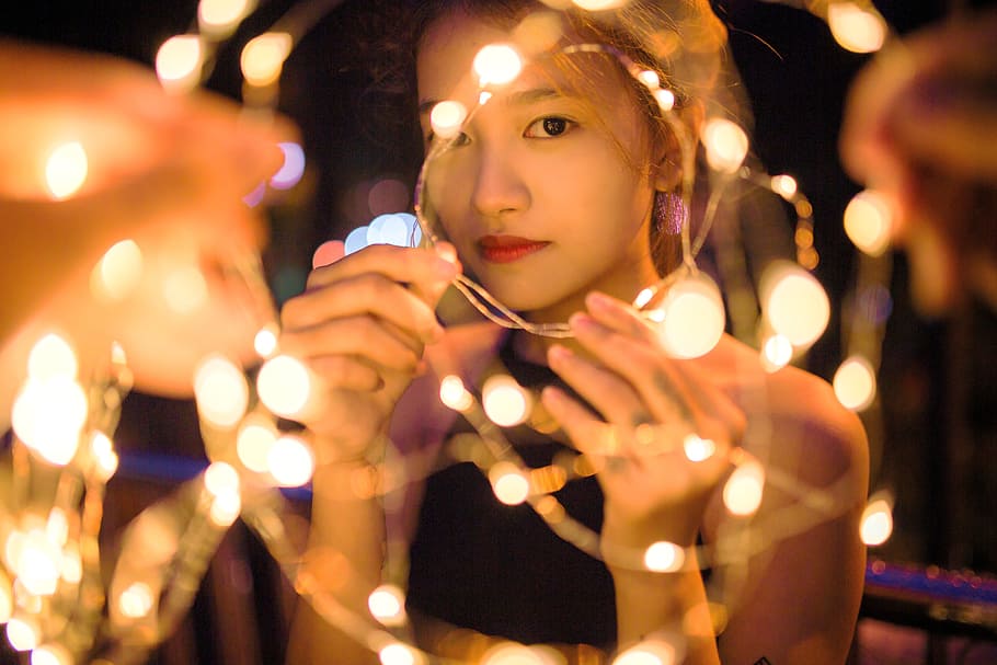 woman holding string lights, girl, night, portrait, led, young