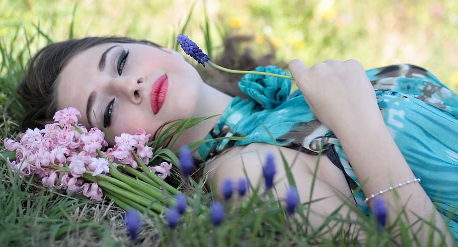 woman lying on grass field holding grape hyacinth flowers, girl, HD wallpaper