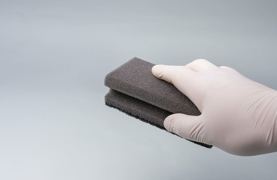 person wearing white glove holding black brick, hand, clean HD wallpaper
