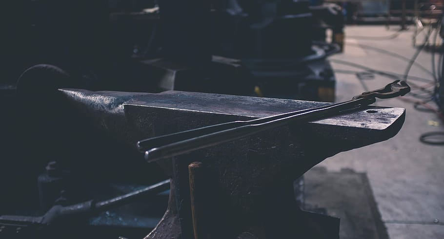 gray metal hand tool on gray bench, black metal anvil near industrial machine HD wallpaper