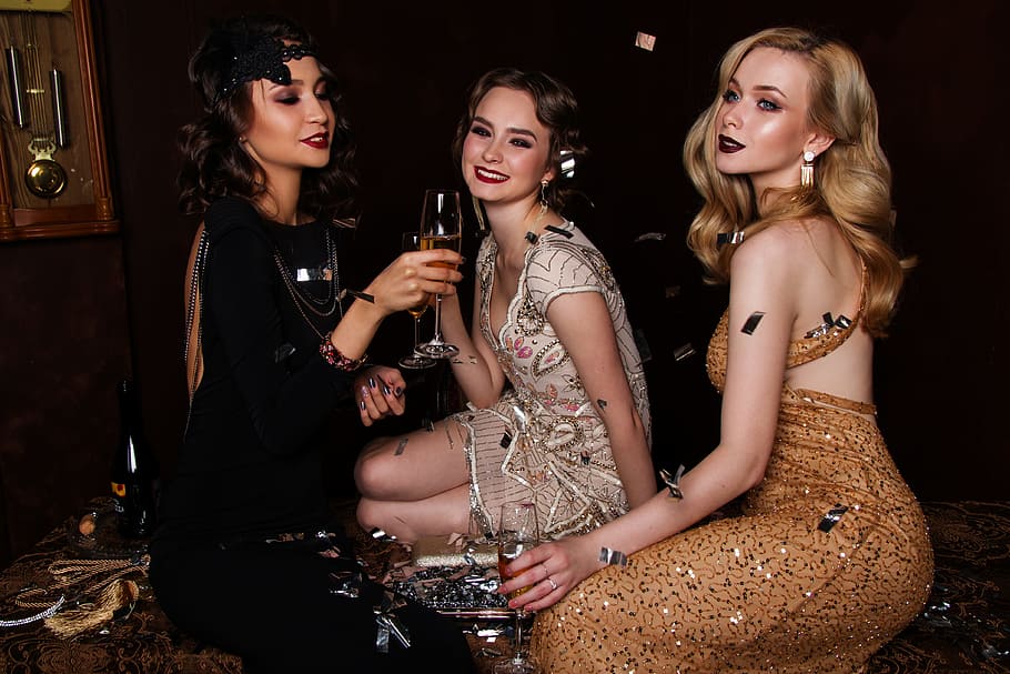three women drinking champagne, blonde, hair, glitter, glamour