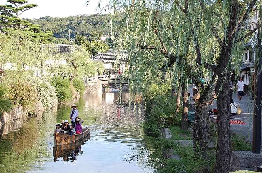 group of person riding on brown row boat, Kurashiki, Okayama