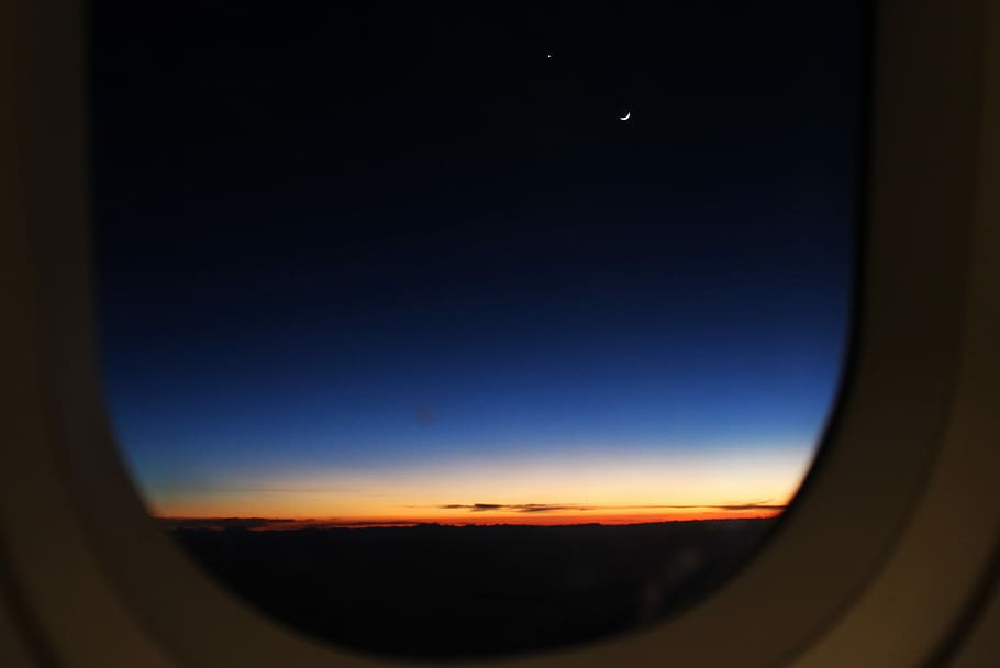 close-up photo of airplane's window, sky, moon, star, airplaine