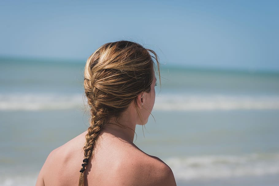 selective focus photography of woman with braided hair standing near beach during daytime HD wallpaper