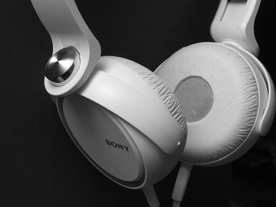closeup photo of white corded Sony full size headphones, music