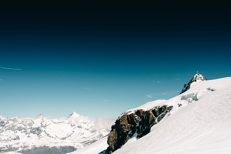 snow covered rock under blue sky, brown hill covered with snow at daytime HD wallpaper