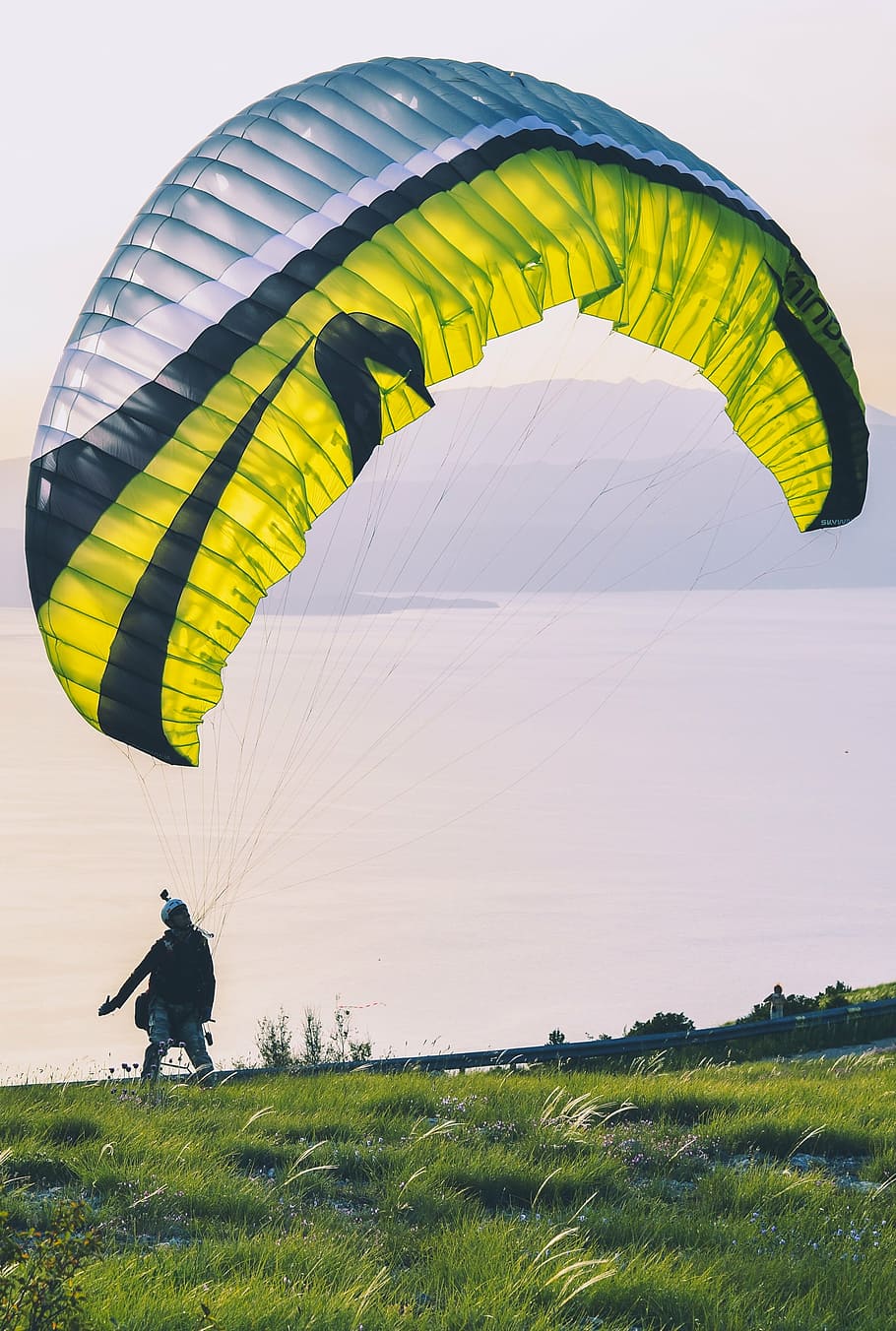 paragliding person, ground, pulling, parachute, air, sports, green