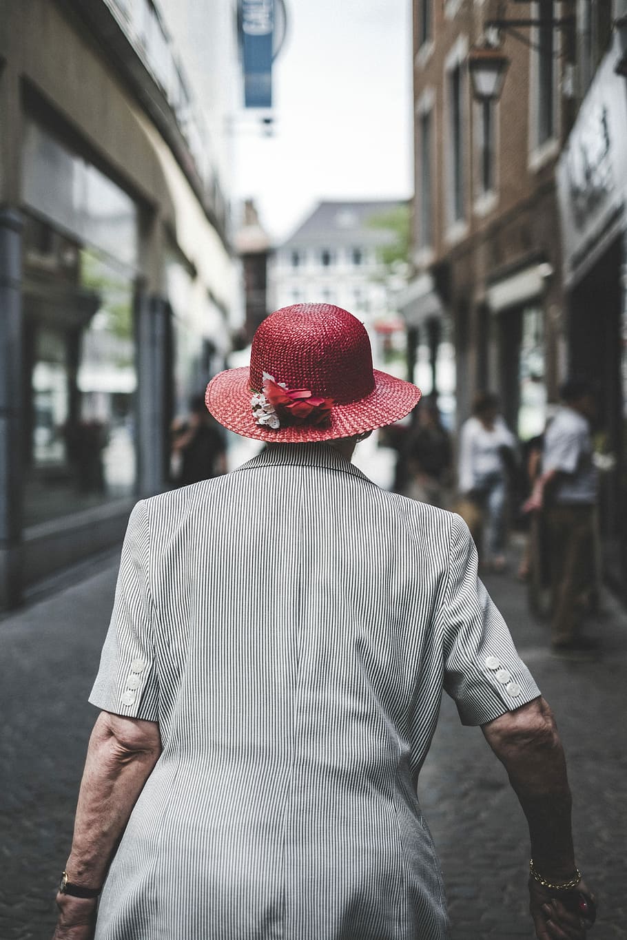 woman wearing red sun hat, woman wearing red sun hat in street