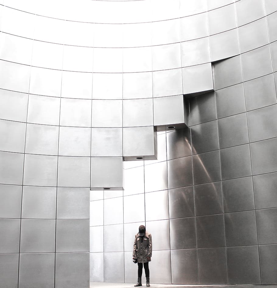 person standing under metal block building, person inside room HD wallpaper