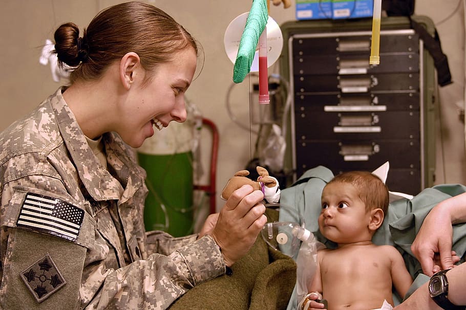 baby with dextrose sitting on sofa near woman wearing soldier uniform, HD wallpaper