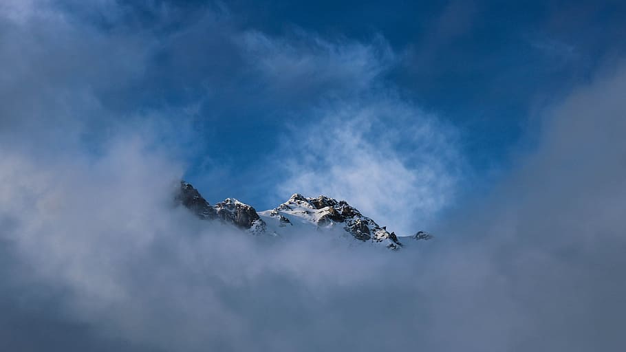 snow top mountain covered with fog during daytime, snow capped mountain behind grey clouds landscape photography during daytime HD wallpaper