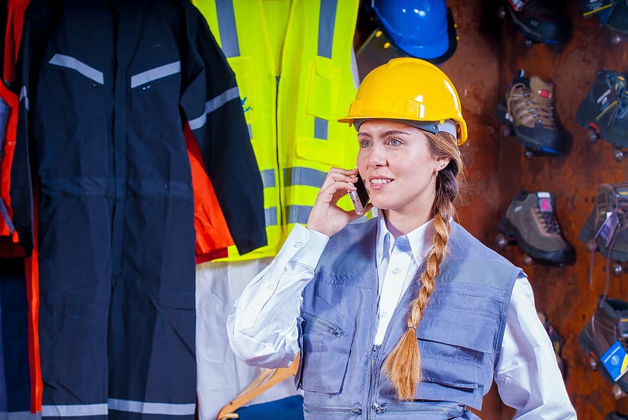 woman wearing yellow hard hat holding smartphone, helmet, industrial, HD wallpaper