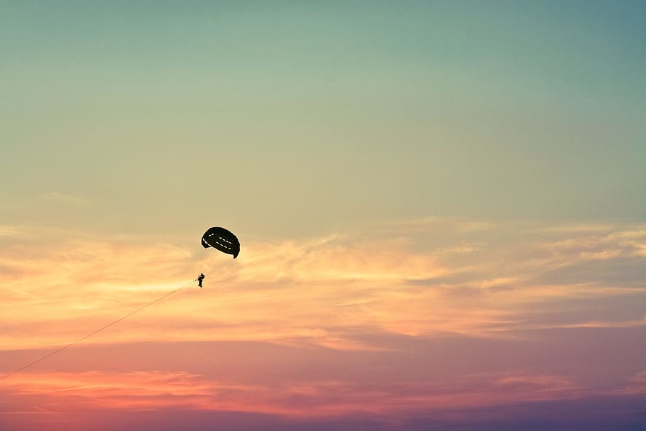 dusk silhouette photo of person with parachute during sunset, person on parachute during daytime HD wallpaper