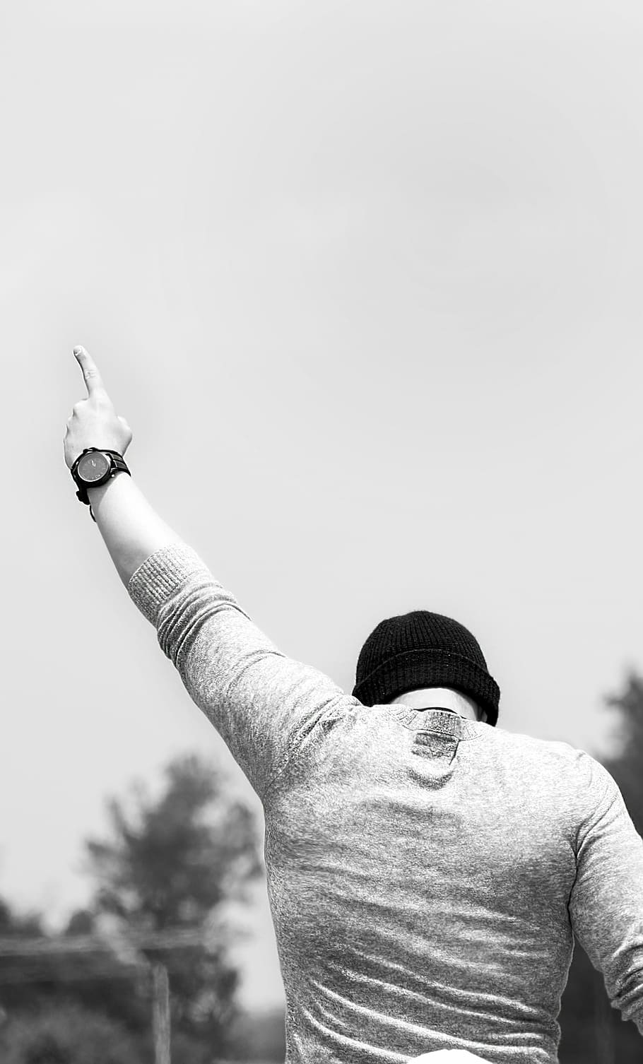 man wearing knit hat pointing his left hand at the sky during day, HD wallpaper