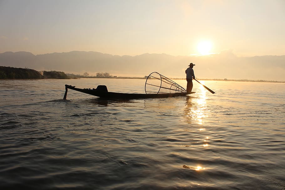 fisherman at middle of water during sunset, boat, inle lake, myanmar