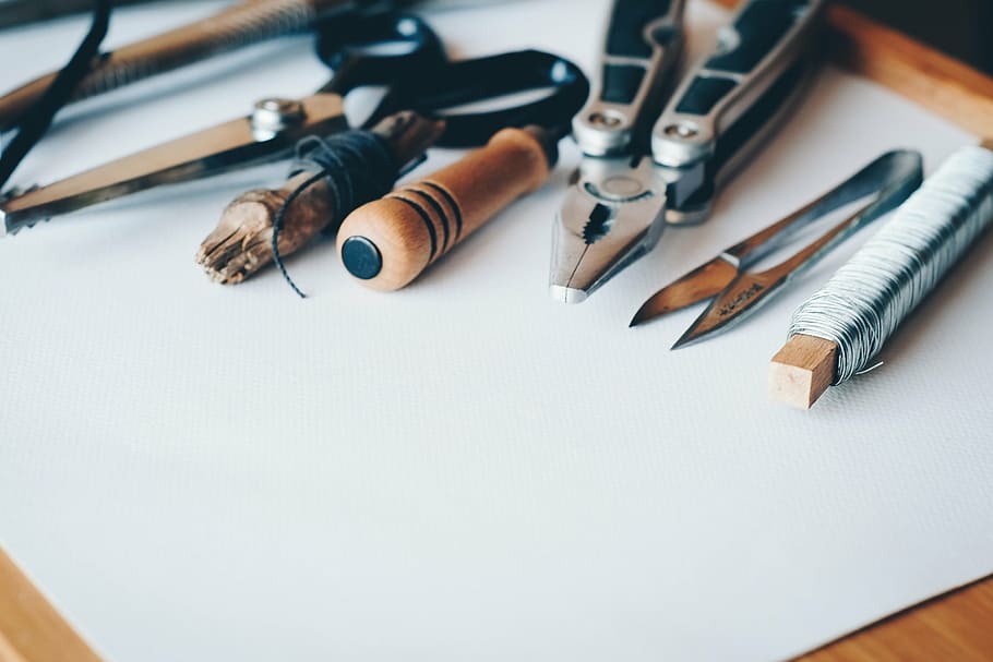 selective focus photography of pliers and scissors on white printer paper HD wallpaper
