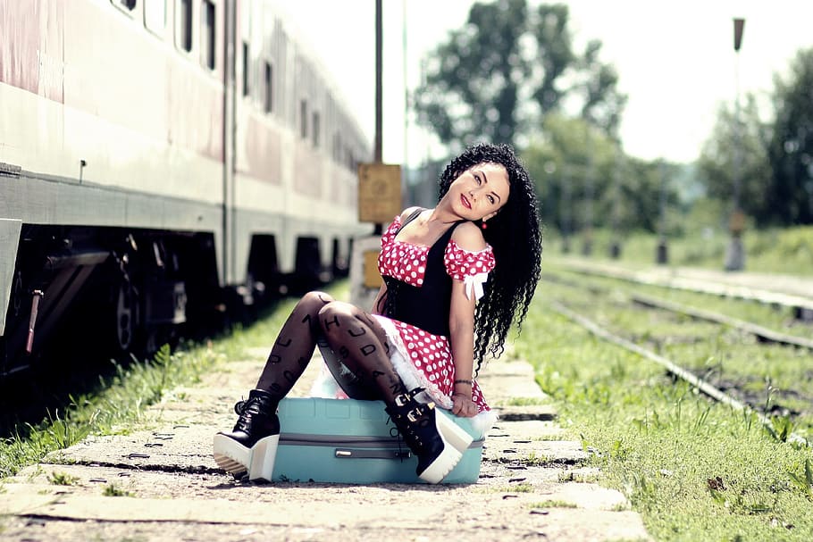 girl-train-station-calling-suitcase.jpg