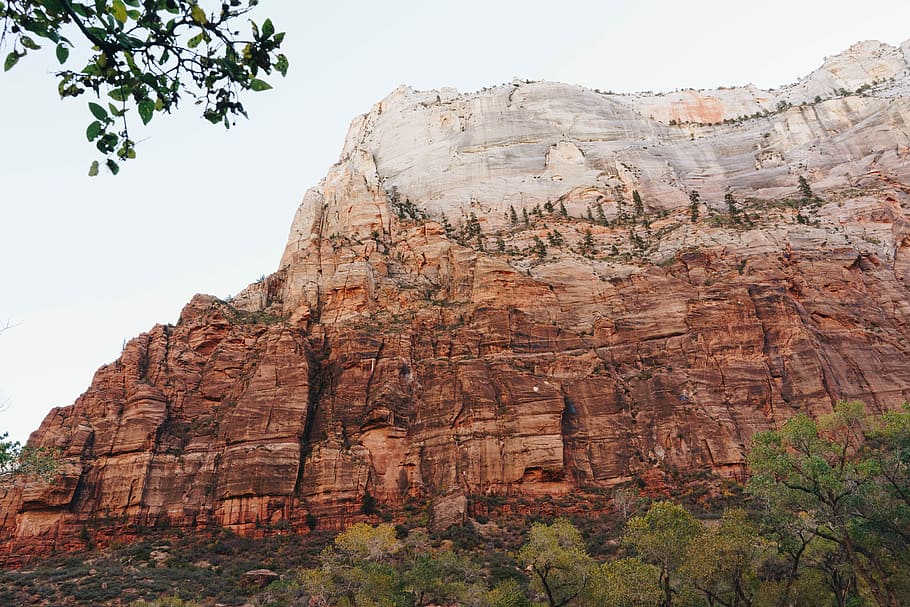low angle photography of rocks, photo of brown rocky mountain during daytime HD wallpaper