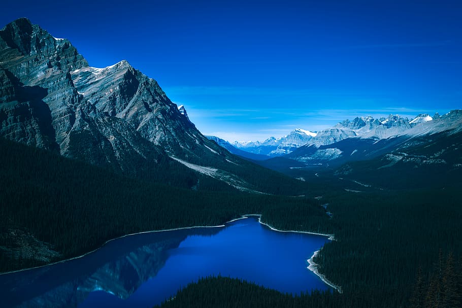bird's eye view photo of river near mountain, lake beside mountain under blue sky HD wallpaper
