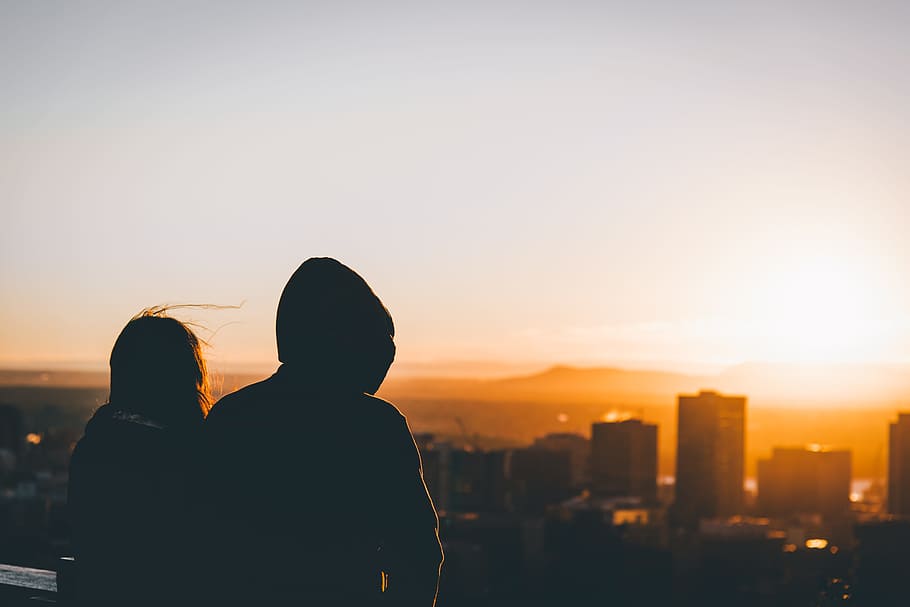 man and woman watching sunset, silhouette photo of man and woman