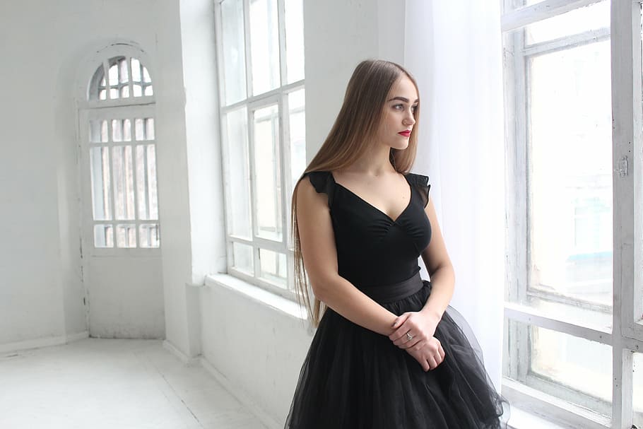 photo of woman wearing black plunging sleeveless dress standing near window, HD wallpaper