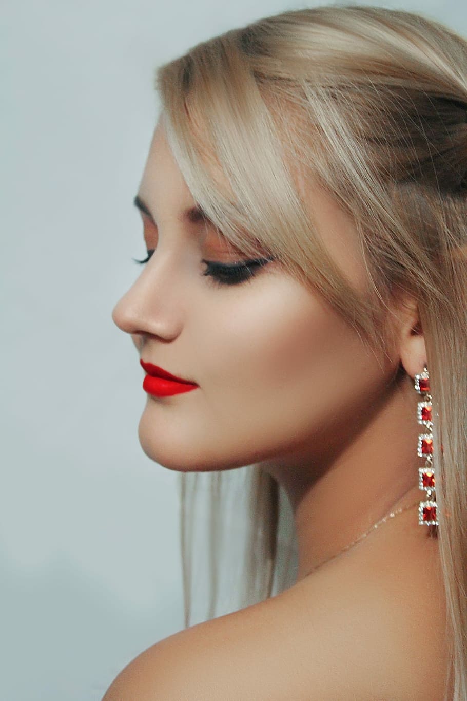 woman wearing pink lipstick and silver-colored earring, fashion