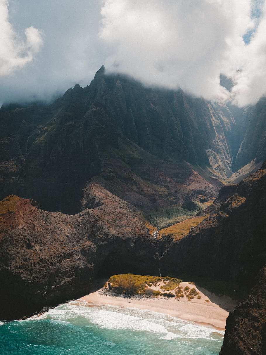 mountain covered of clouds, aerial view photography of seashore HD wallpaper