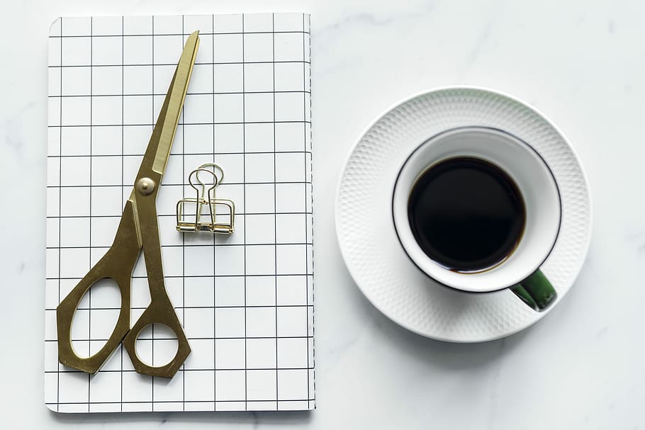 flat-lay photography of cup with coffee on saucer and scissors HD wallpaper
