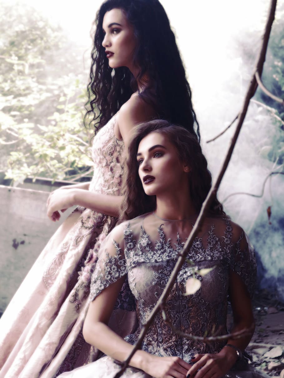 two woman wearing beige gowns doing pictorial, fashion shoot