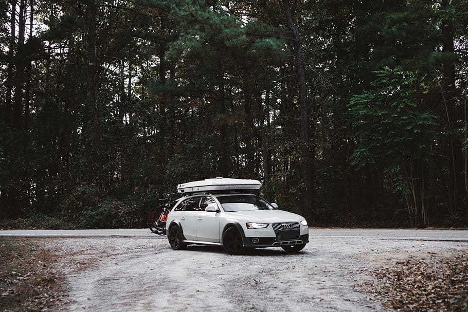 white Audi 5-door hatchback parked on dirt road near trees HD wallpaper