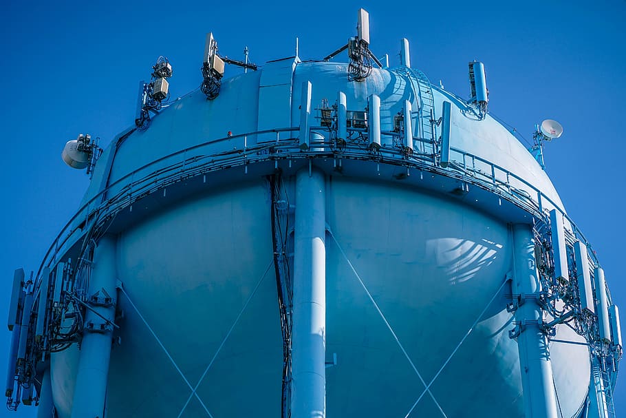 low angle photo of blue metal tank, photo of gray metal industrial machine HD wallpaper