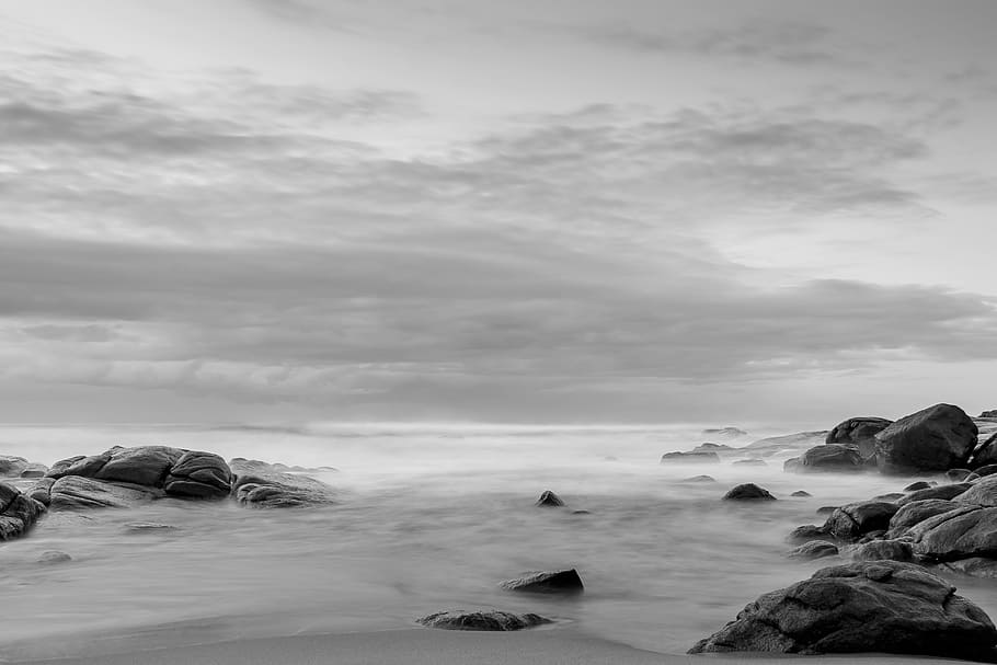 grayscale photo of rock formation surrounded with body of water, grayscale photo of seashore HD wallpaper