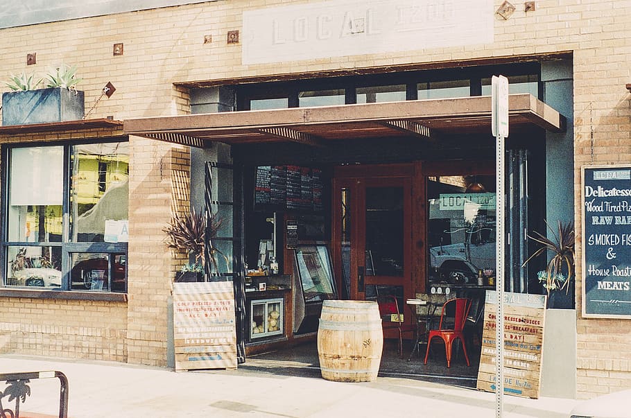 brown wooden barrel in front of store, signboard, near, glasses