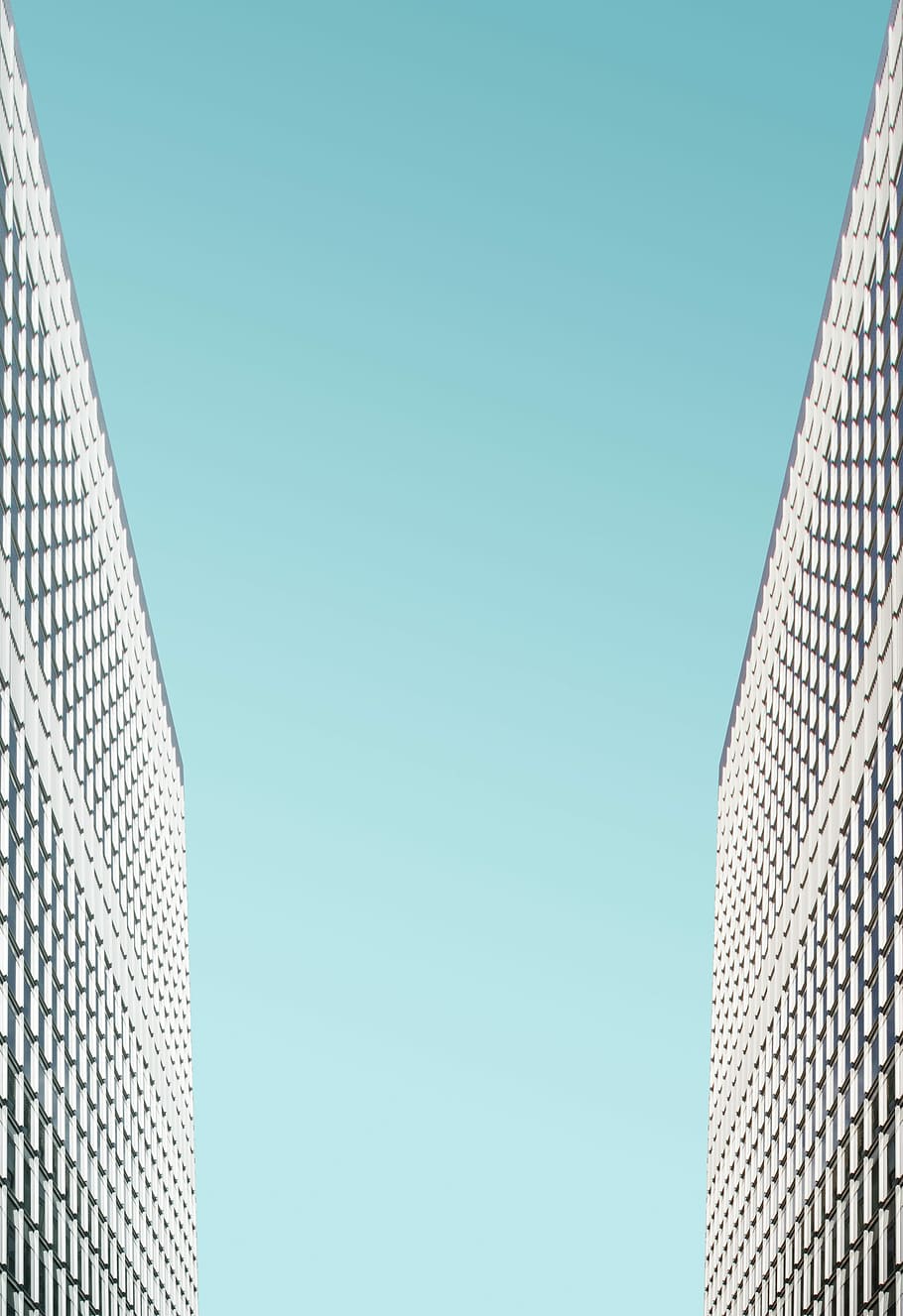 low-angle of building, two gray-and-black building with blue sky HD wallpaper