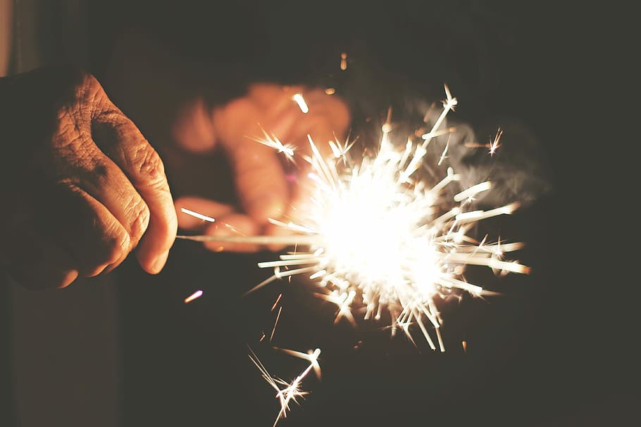 person holding a firework, sparks, sparkler, fire - Natural Phenomenon HD wallpaper
