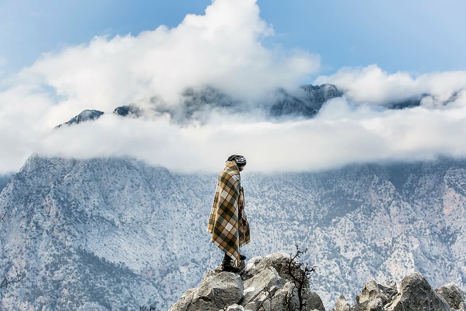 man standing on mountain edge, nomad, bedouin, mountains, wild