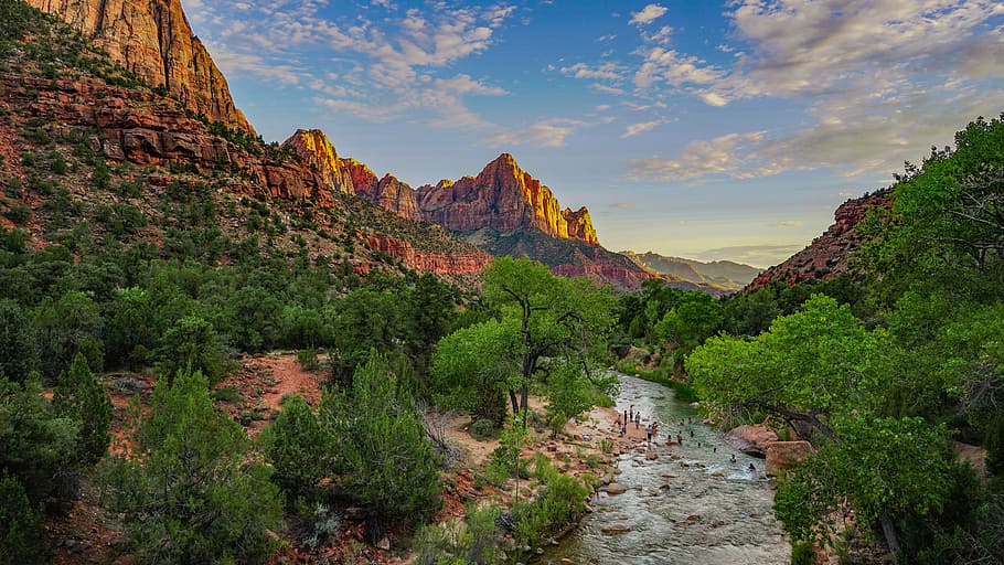group of people near the river, group of people near brown rock formation HD wallpaper