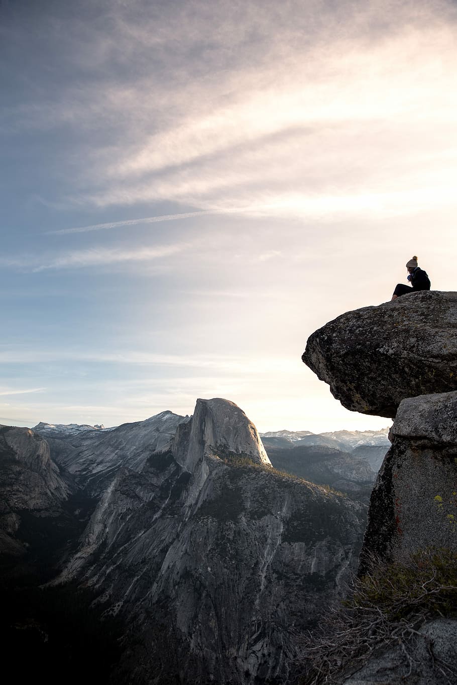 person sitting on gray rock cliff at daytime, person sitting on rock mountain cliff HD wallpaper