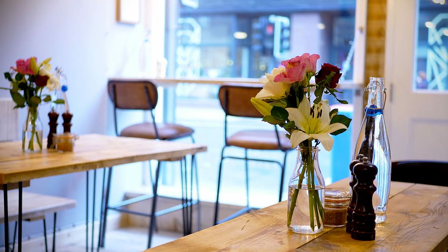 Cafe interior, pink and white roses on vase placed brown wooden table HD wallpaper