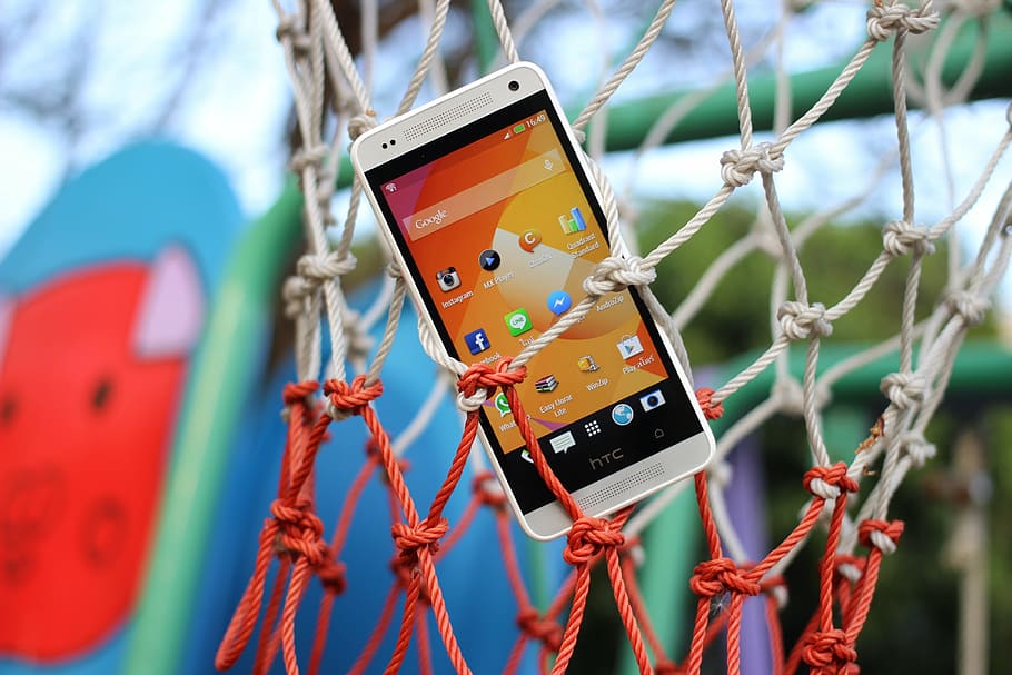 HD wallpaper: white HTC Android smartphone hanged on basketball net, mobile  | Wallpaper Flare