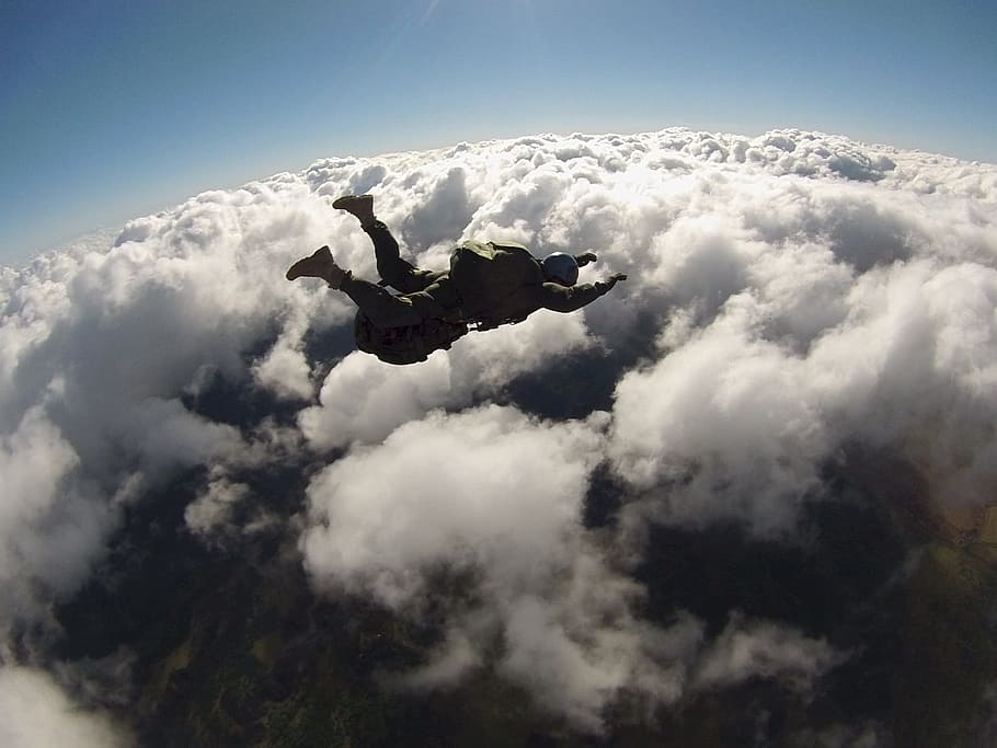 person falling from the sky during daytime, skydiver, parachute