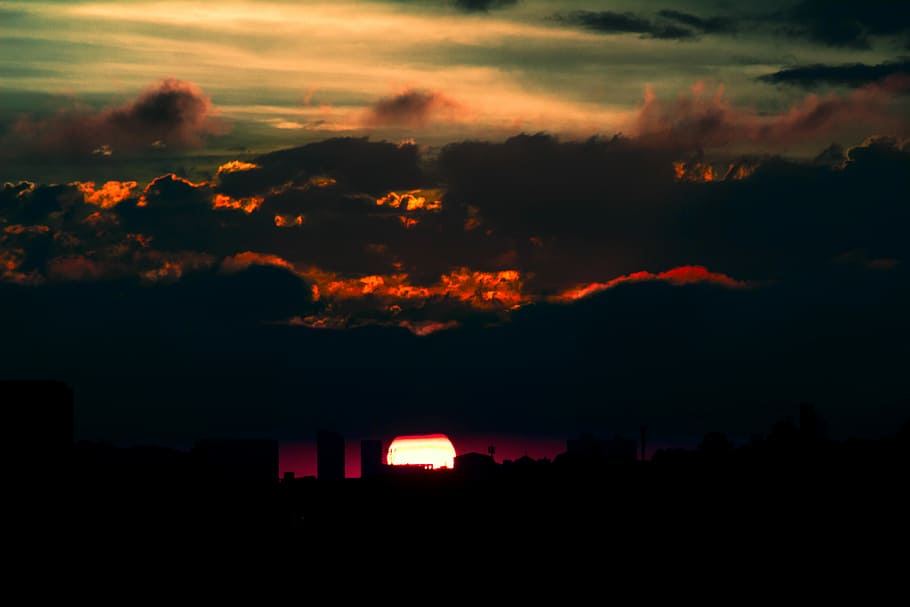 red clouds photo during sunset, silhouette photography of high rise buildings during golden hour HD wallpaper