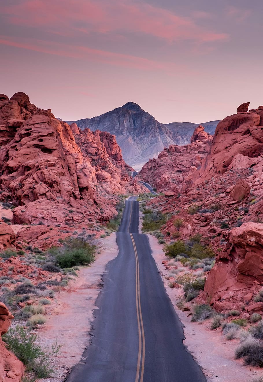 photo of empty road between rock formations, gray asphalt road between rocks HD wallpaper