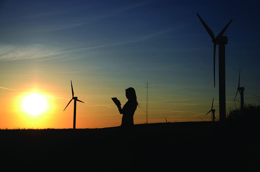 Silhouette Of Woman Holding Book Near Windmills, backlit, dawn HD wallpaper