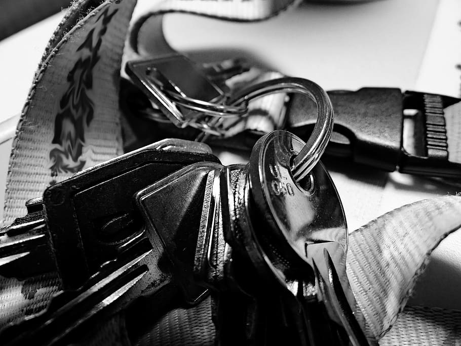 key, strap, black and white, close-up, table, indoors, focus on foreground HD wallpaper