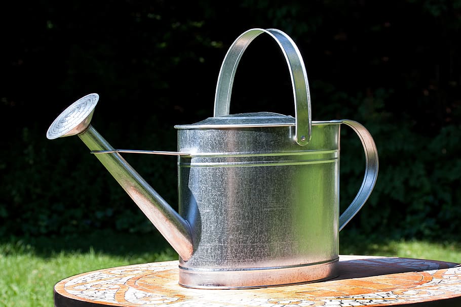 closeup photography of gray stainless steel watering can on table during daytime HD wallpaper