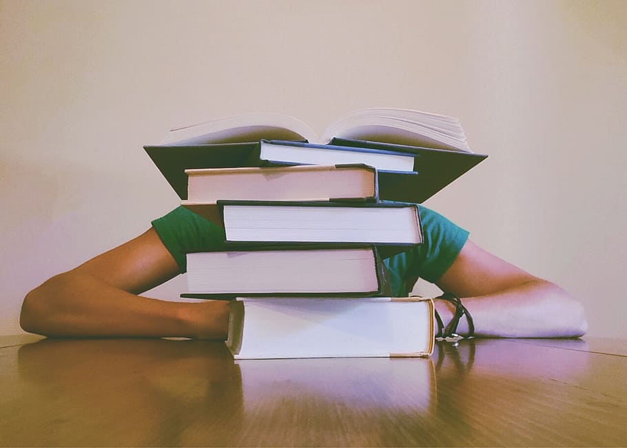 person sitting in front of piled of books on top of table, student HD wallpaper